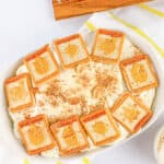 A white dish topped with banana pudding.