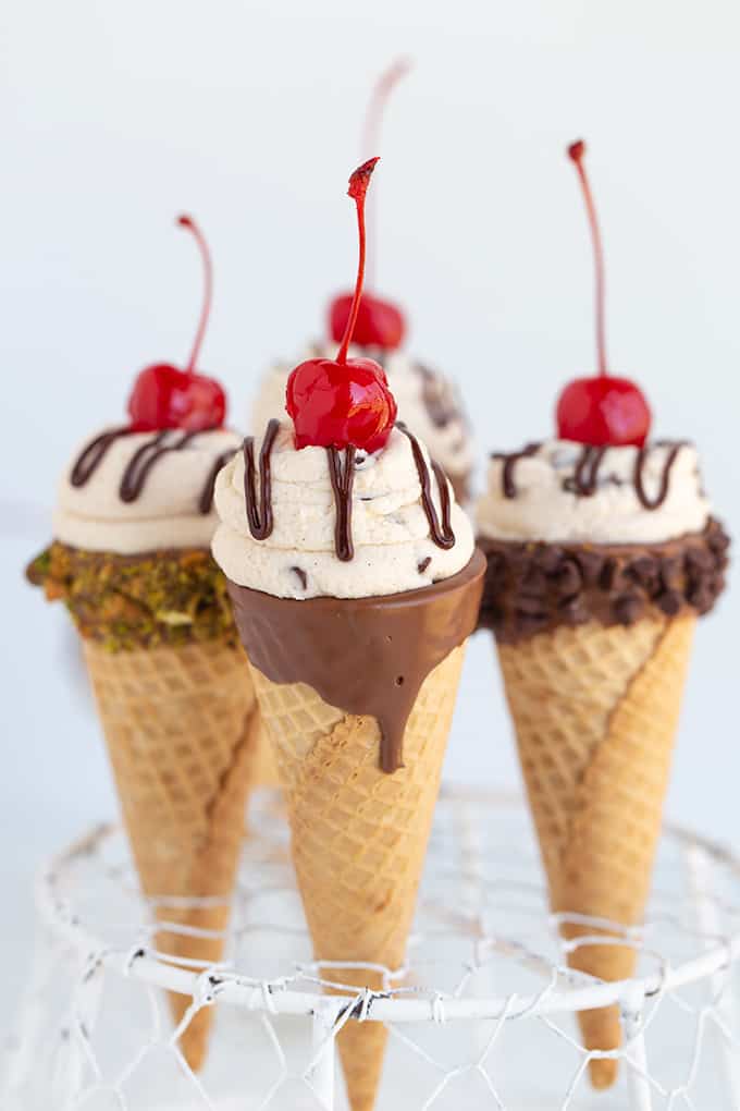 4 cones stuck in a wire basket on a white surface