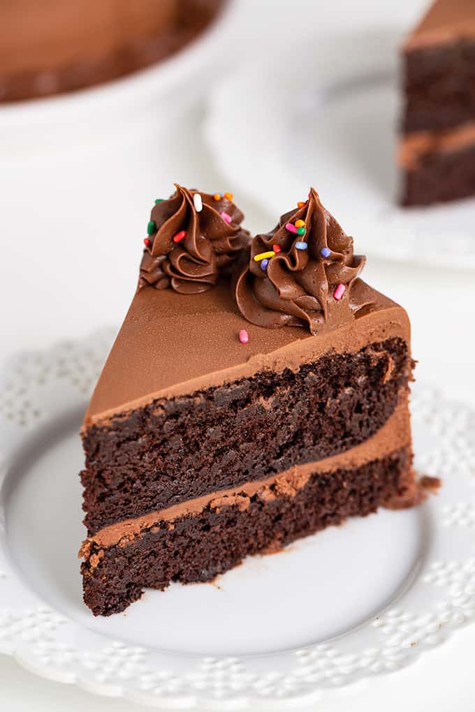 showing a slice of cake slightly overhead on a white plate with a white background