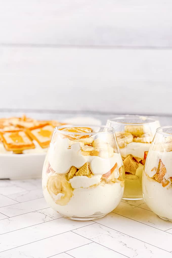 glasses of dessert on a white surface 