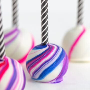 a cake pop with blue, purple, and pink marbling on it