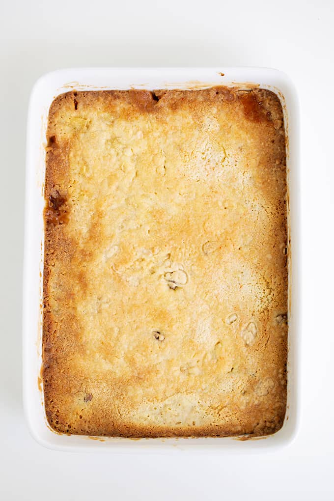 overhead photo of the dump cake in the pan over it's been baked on a white surface