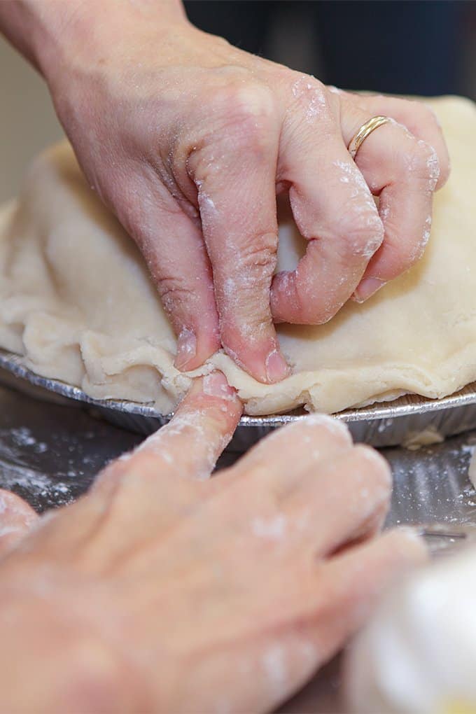 crimping the pie crust with fingers