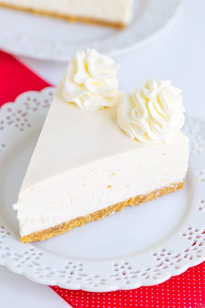 no bake cheesecake on a white plate with a red fabric under the plate