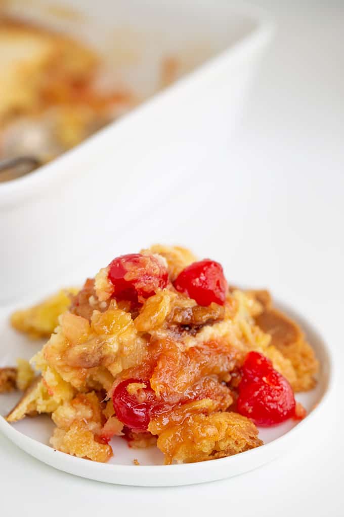 a pile of dump cake on a small white plate on a white background