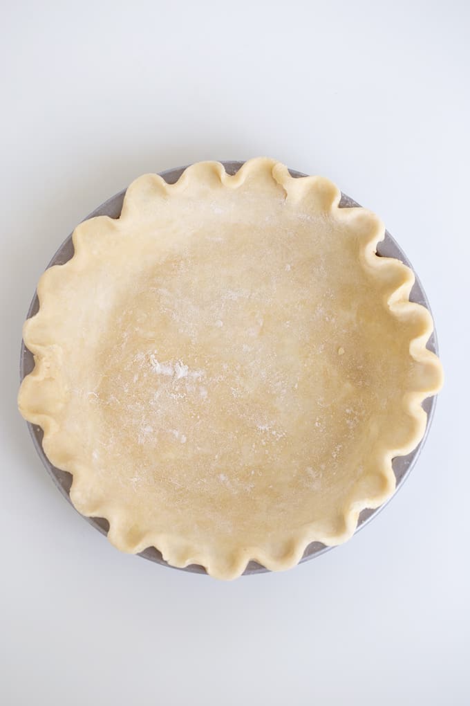 overhead view of a unbaked pie crust in a pan