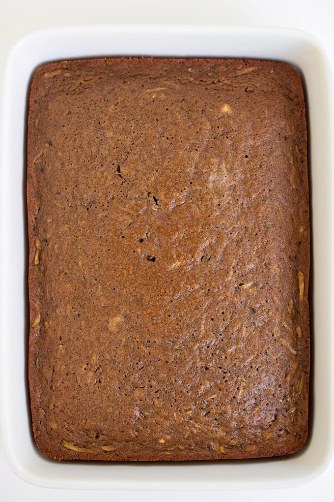 overhead image of the whole cake in a white pan on a white surface