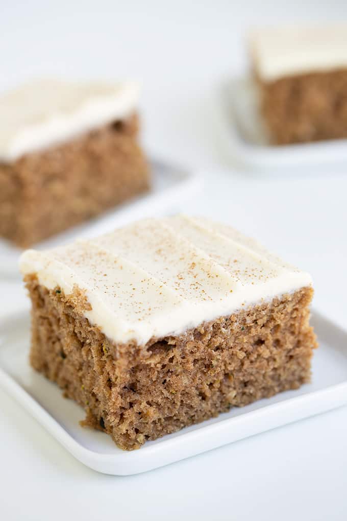 slice of cake on a small white plate on a white surface