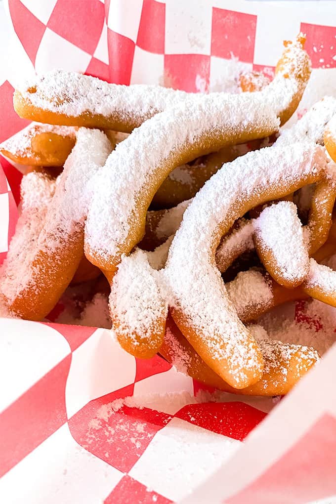 funnel cake fries on a checked piece of wax paper