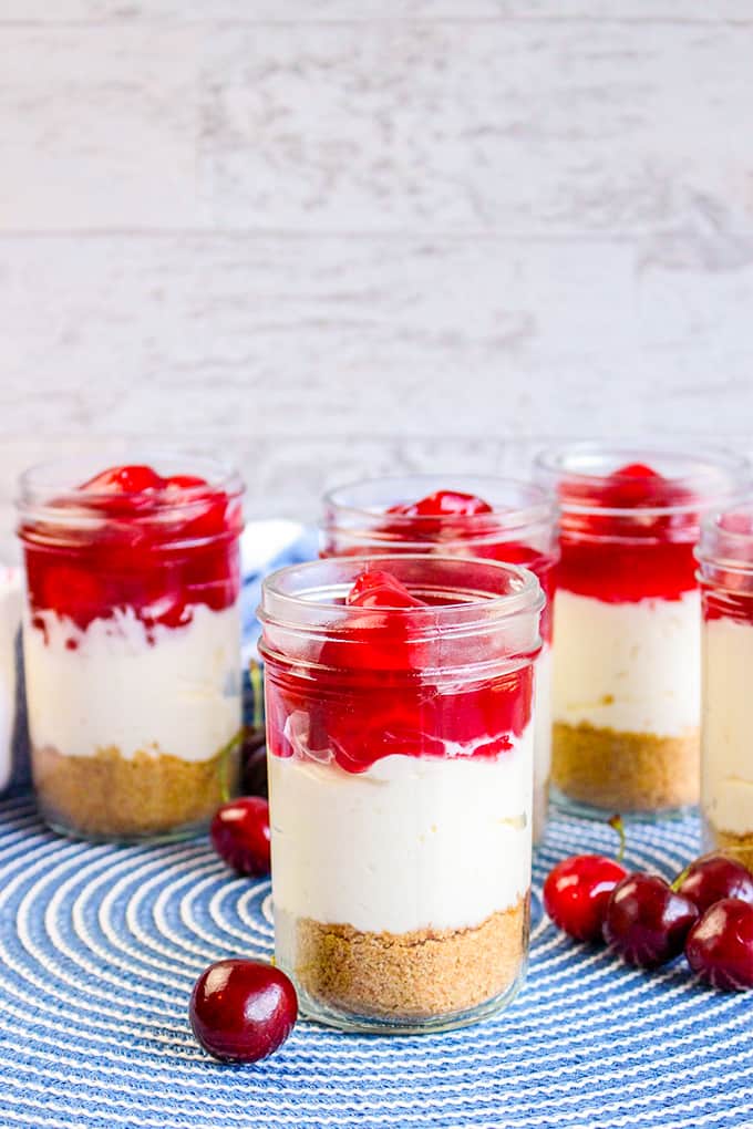jars of cheesecake on a blue placemat