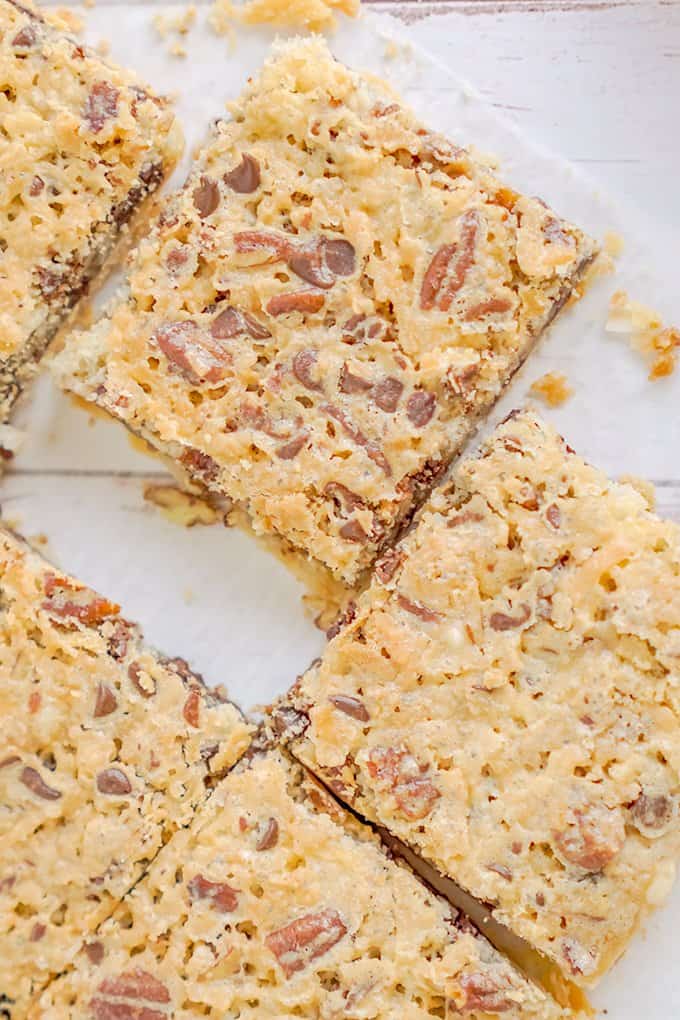 overhead photo showing cut pecan pie bars on a piece of parchment paper