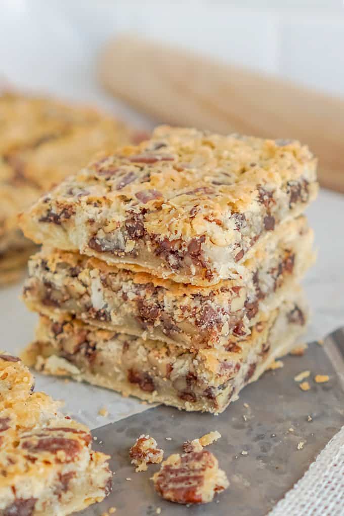 Three chocolate chip pecan pie bars stacked 