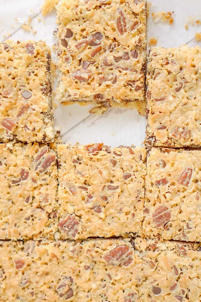 chocolate chip pecan pie bars with coconut on a tray.