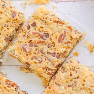 Four squares of graham cracker bars with pecans on top, sprinkled with chocolate chips.