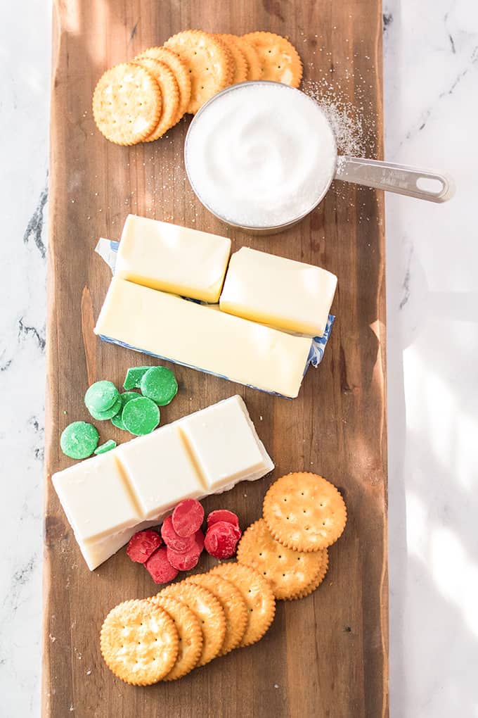 ingredients for Chrsitmas cracker laid out on a cutting board on a marble surface