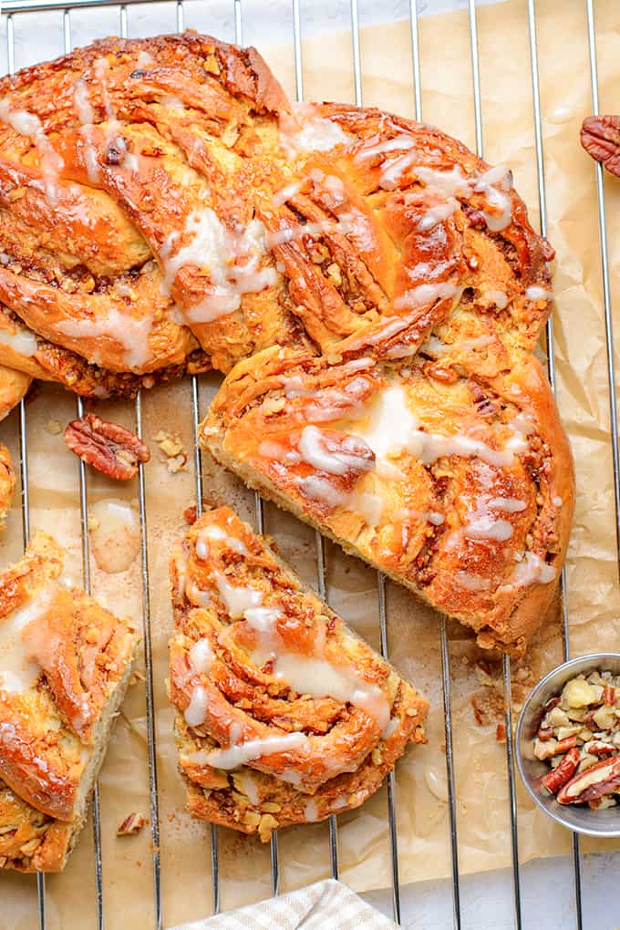 wreath bread with a slice cut out on a wire rack