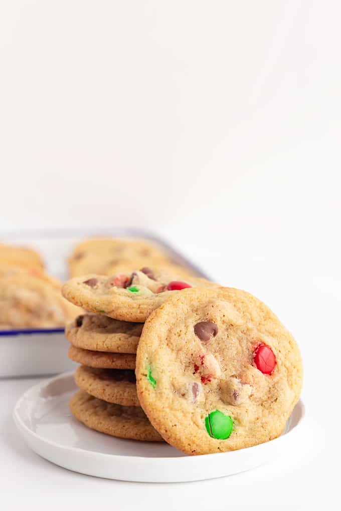 small white plate with cookies stacked on it on a white surface