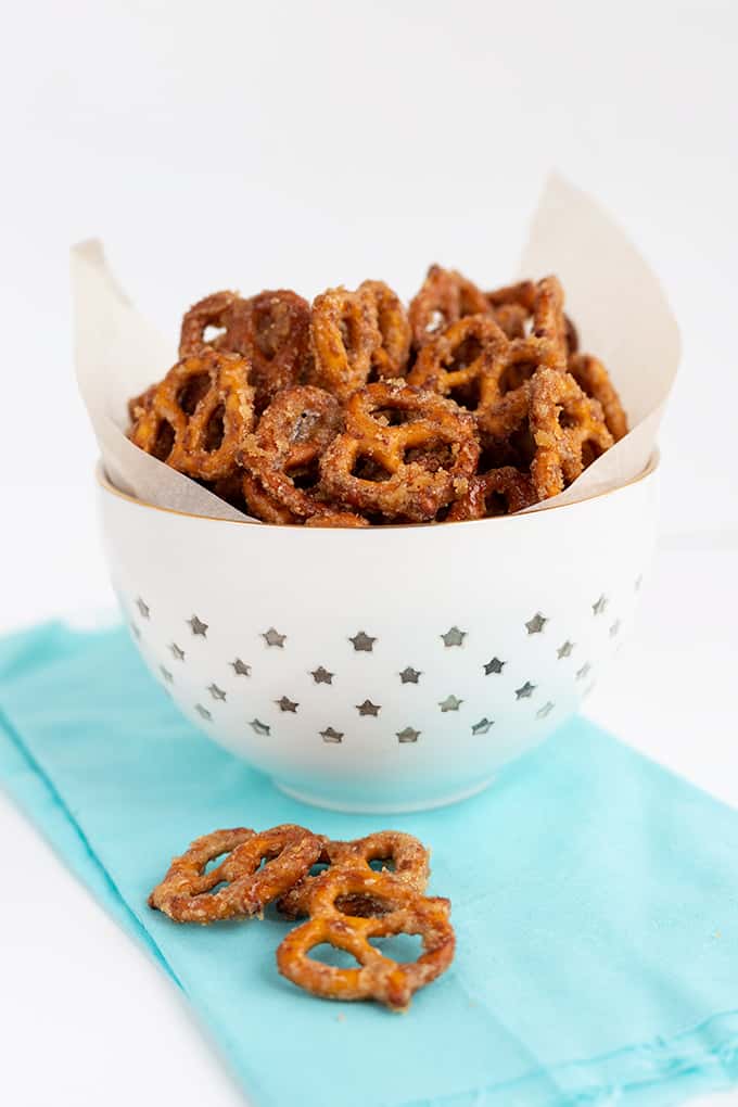 bowl of sugar coated pretzels on a light blue linen with a white surface