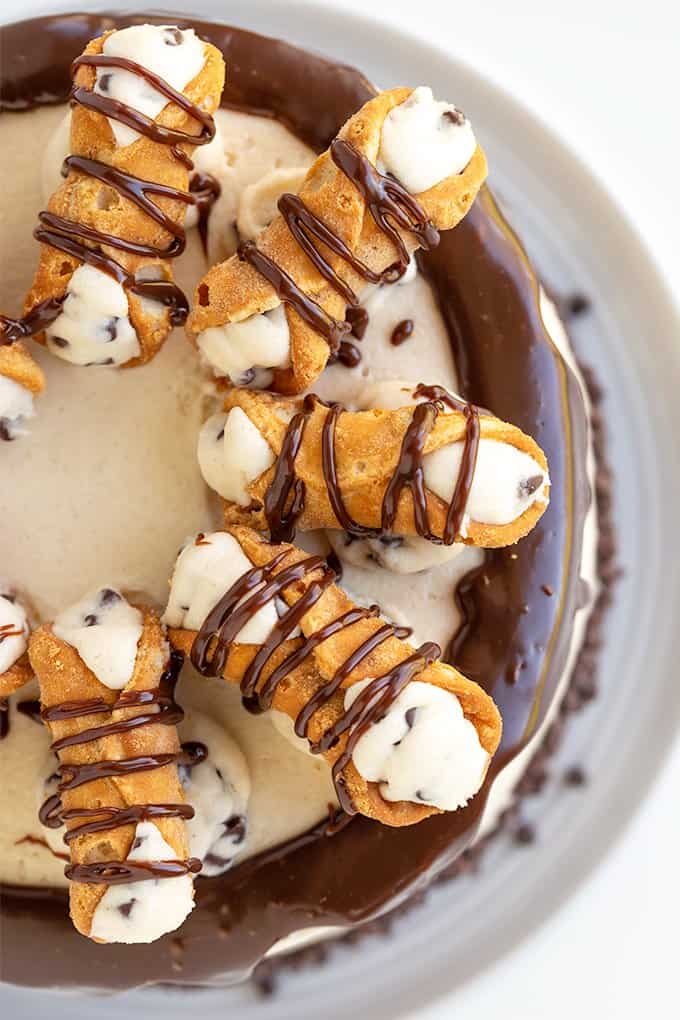 overhead photo of the cake showing the mini cannoli and ganache on a white background