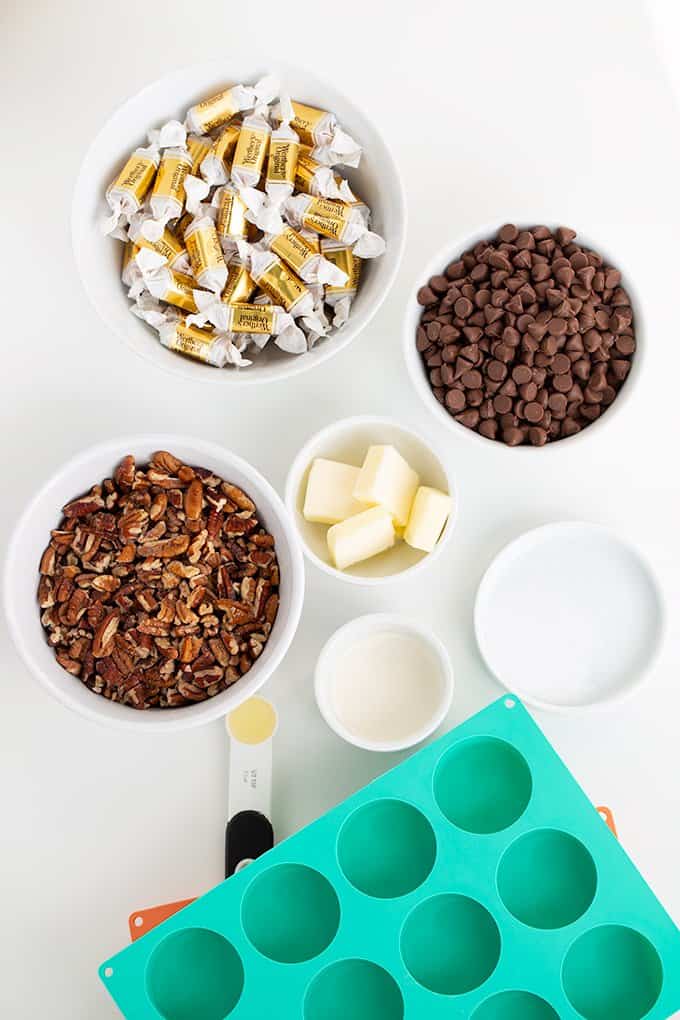overhead view of the chocolate turtle ingredients on a white surface