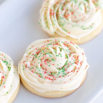 frosted cookies on a white platter