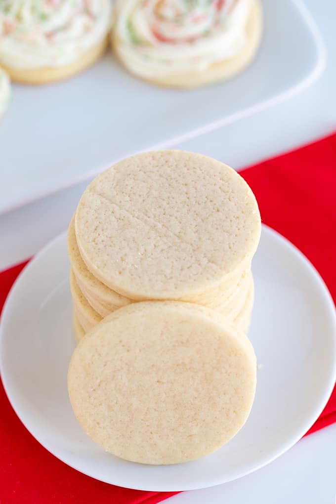 cookies stacked on a small dessert plate with a red linen under the plate