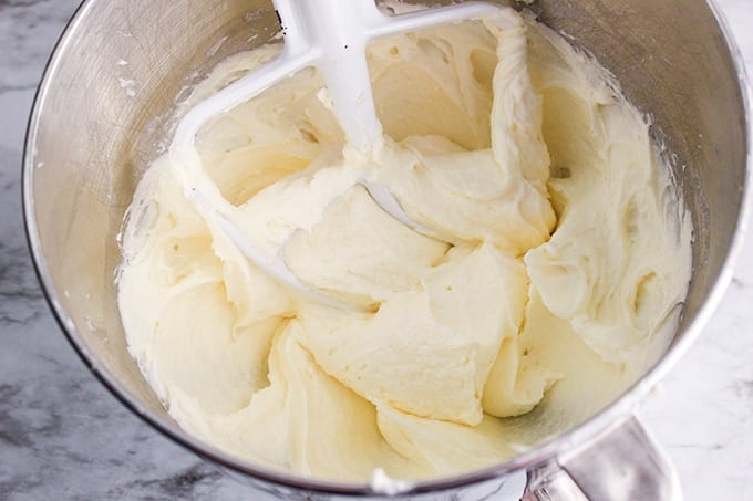 mixture in a metal mixing bowl with a paddle attachment