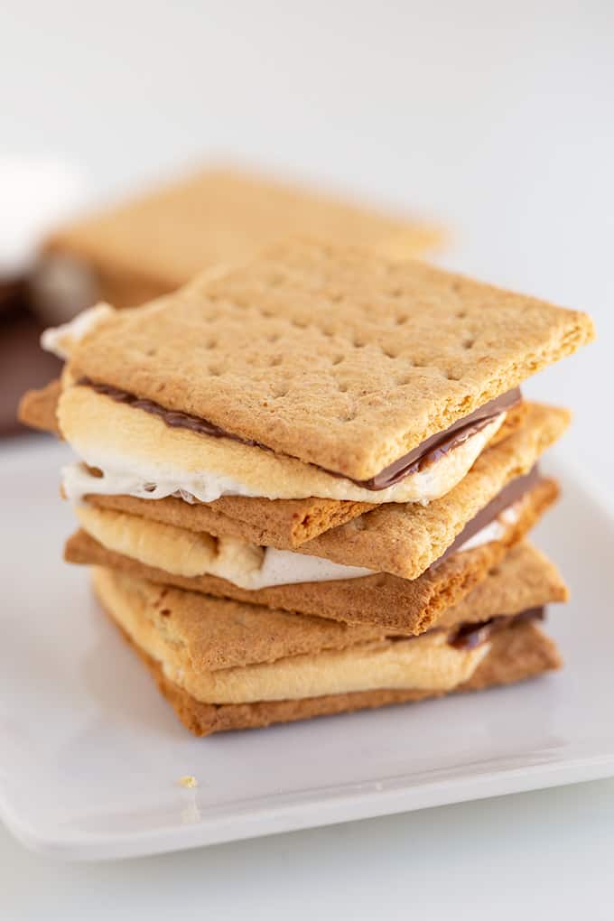 close up of the stack of s'mores on a white plate on a white background