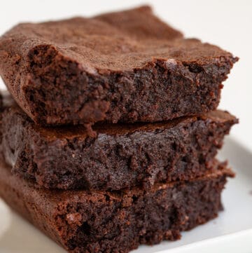 Homemade brownies on a white plate.