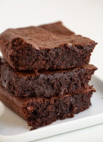 Homemade brownies on a white plate.