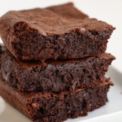 Homemade brownies on a white plate.