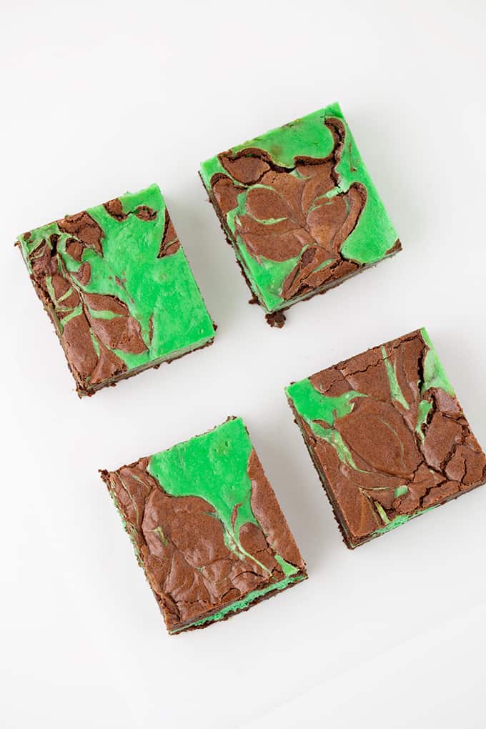 overhead photo of 4 brownies on a white surface