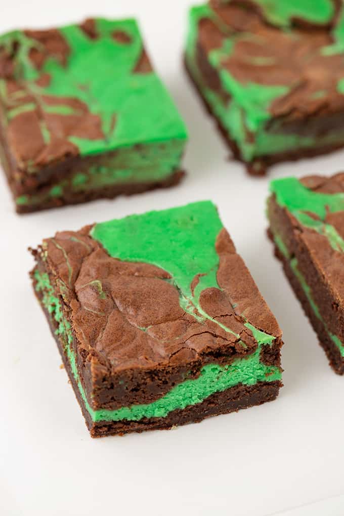 brownies showing the side view with the layers of fudgy brownies and green cheesecake