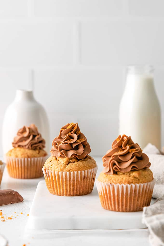 Peanut butter cupcakes on a white cutting board.