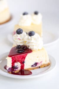 A slice of blueberry cheesecake on a plate.