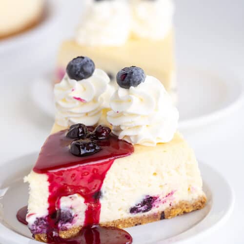 A slice of blueberry cheesecake on a plate.