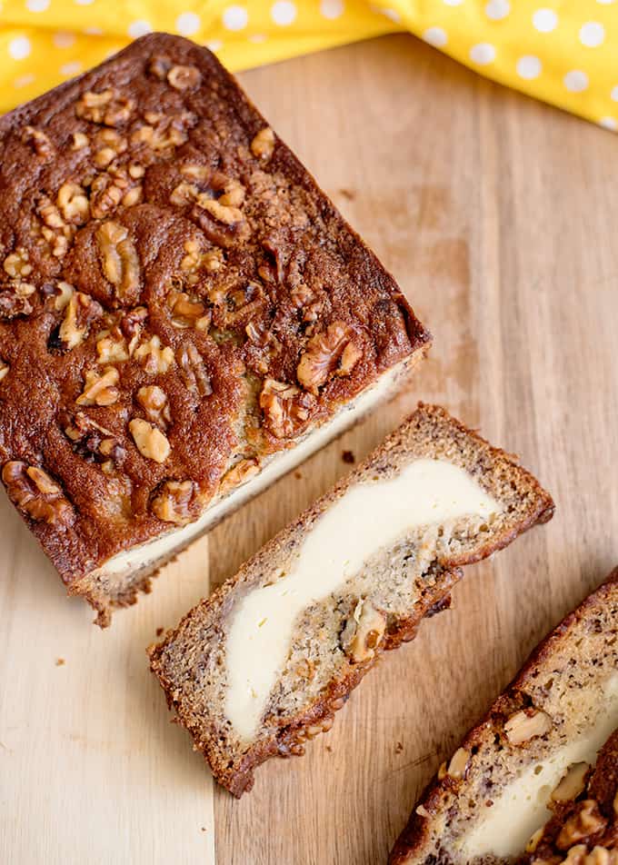 Top down view of cream cheese banana bread topped with walnuts.