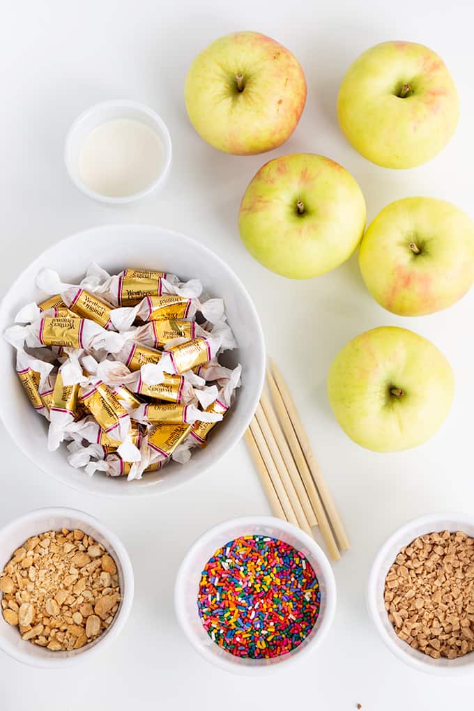showing caramel apple ingredients from above on a white surface