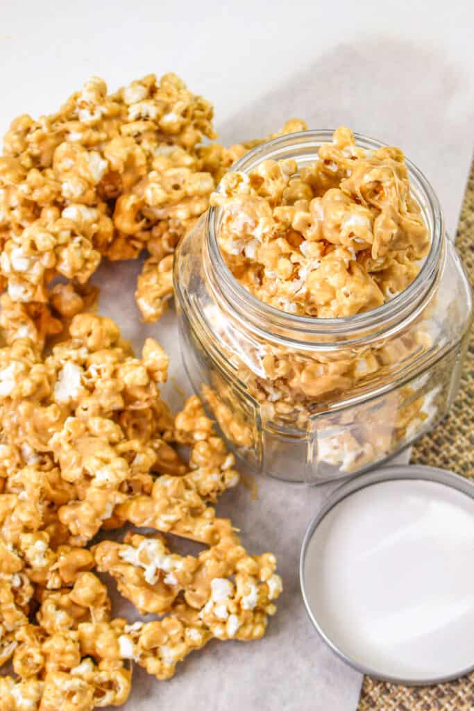 Peanut butter popcorn close up top down view in a glass jar.