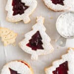 christmas tree linzer cookies on a piece of parchment paper