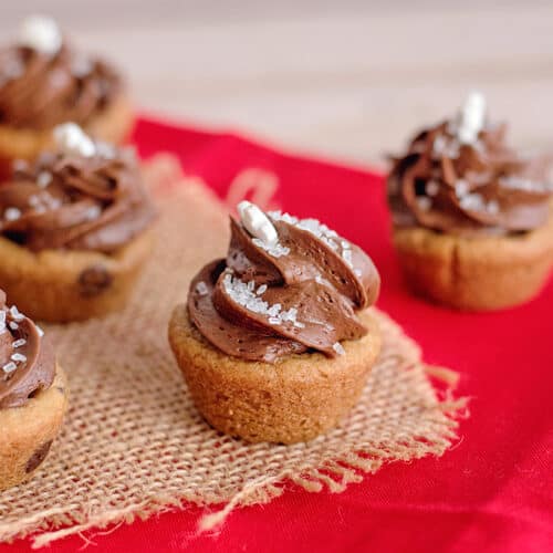 Mini Caramel Chocolate Cookie Cup on a piece of burlap on a red fabric