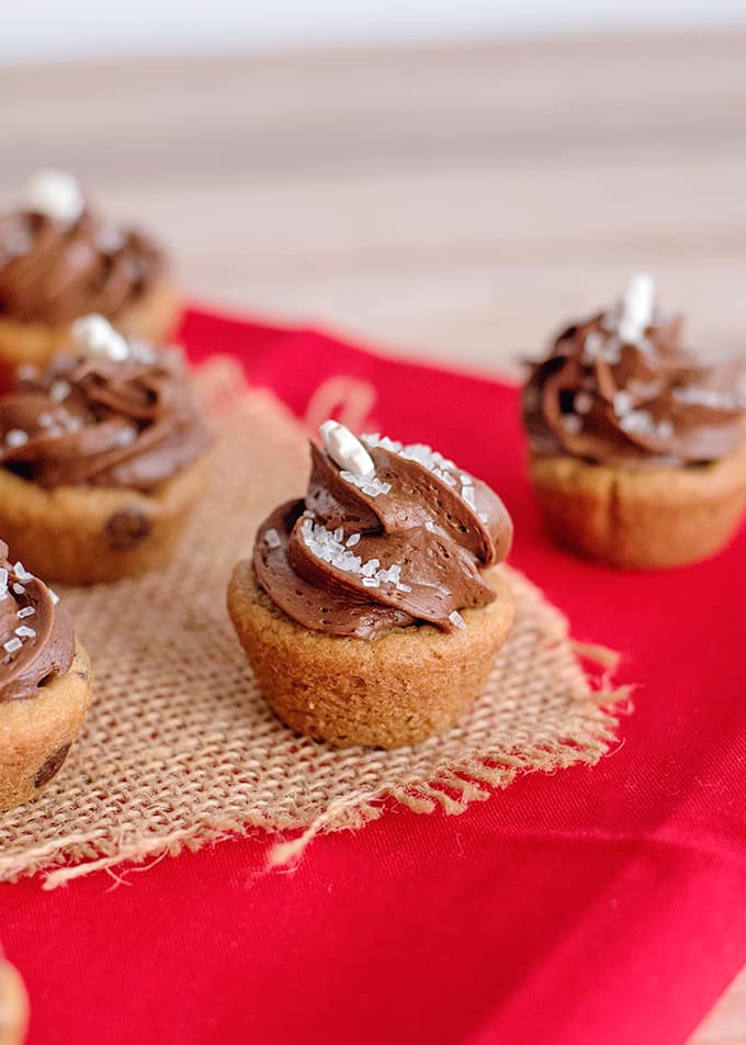 Mini Caramel Chocolate Cookie Cup on a piece of burlap on a red fabric