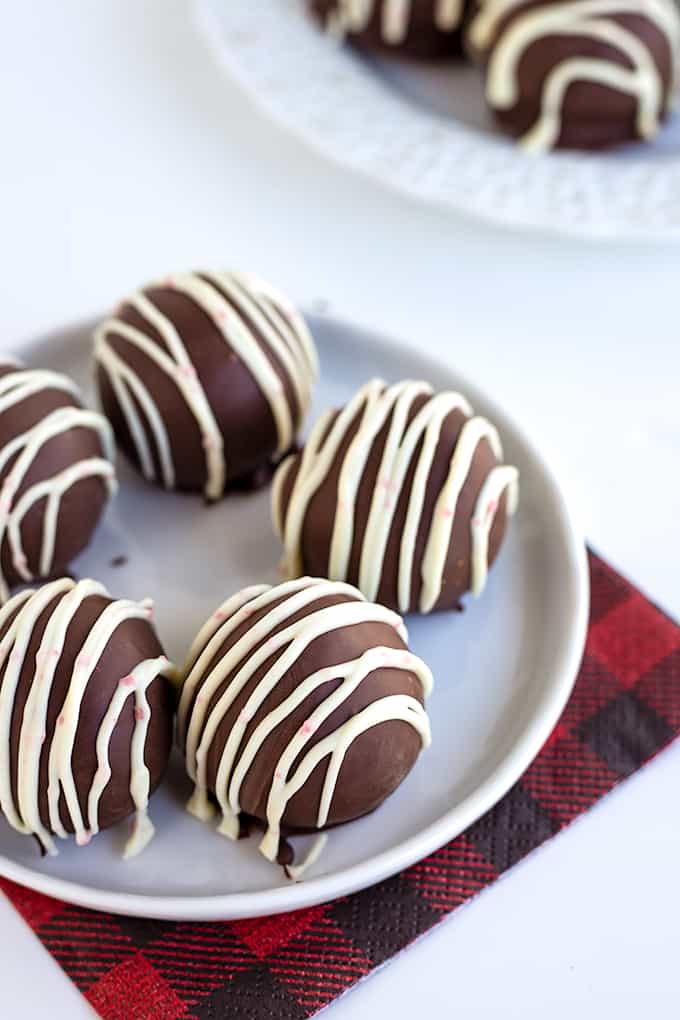 Oreo cookie balls on a buffalo plaid napkin on a white surface