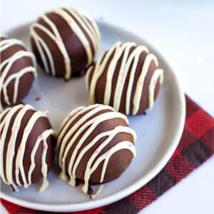 Peppermint Oreo Truffles on a white background with a red and black checkered napkin