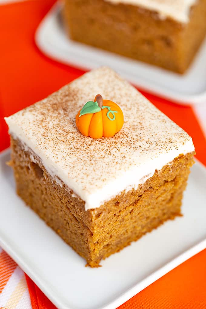 Close up top down view of single slice of pumpkin cake on a square white plate 
