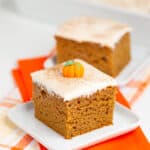 A slice of pumpkin cake displayed with orange napkins.