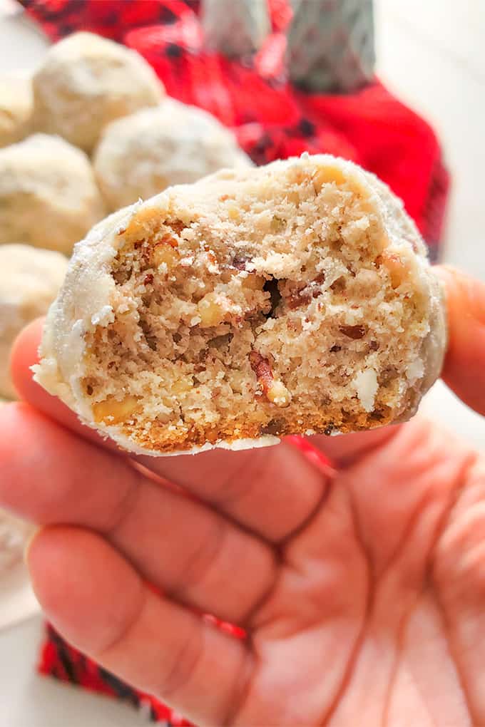 Cutaway view of the inside of a pecan snowball cookie close-up.