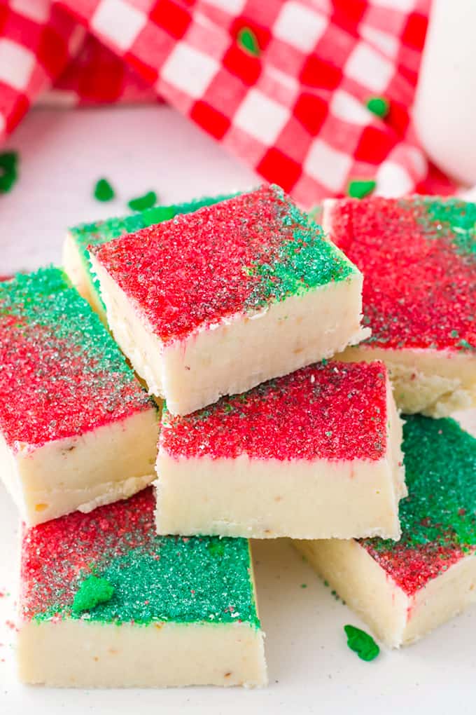 stacked pieces of fudge with a red and white linen behind it on a white surface