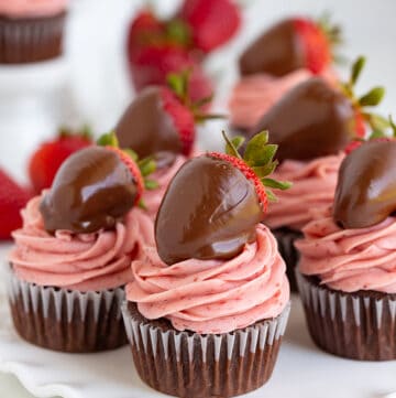 Delicious cupcakes featuring the perfect combination of chocolate and strawberry flavors, impeccably presented on a white plate.