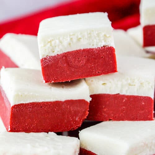 red velvet fudge stacked with a red linen behind it